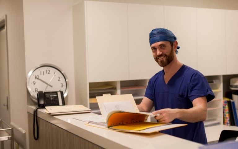 Male doctor smiling at the camera